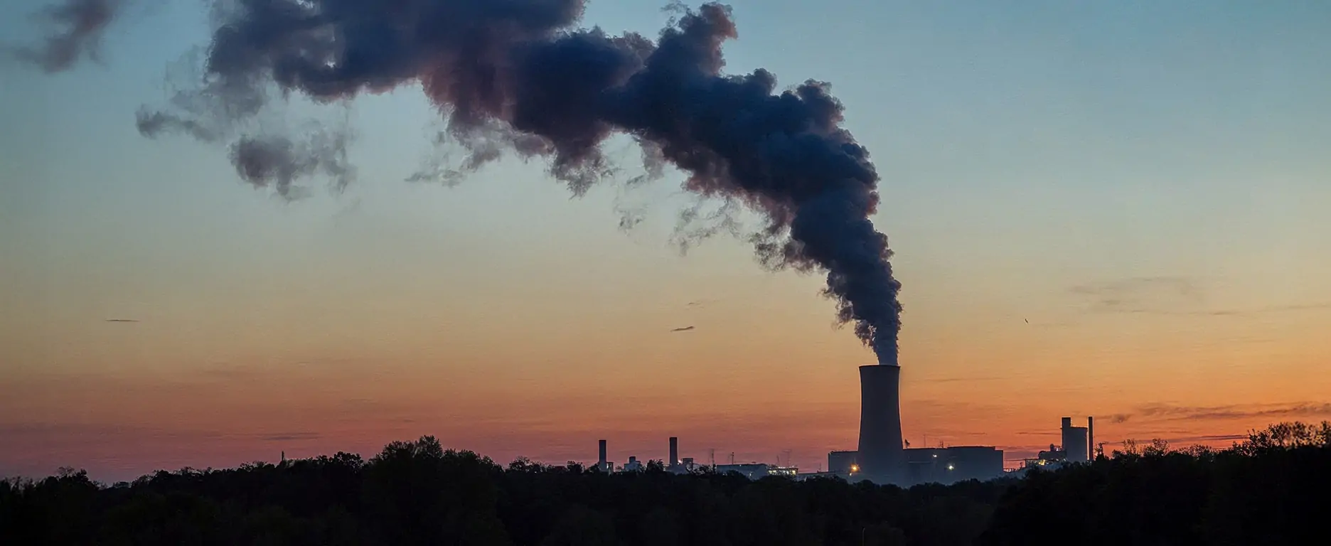 Dirty peaker plant with smokestacks billowing out smoke and pollution